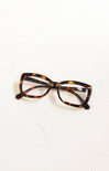 Tortoiseshell cat-eye glasses on a white background