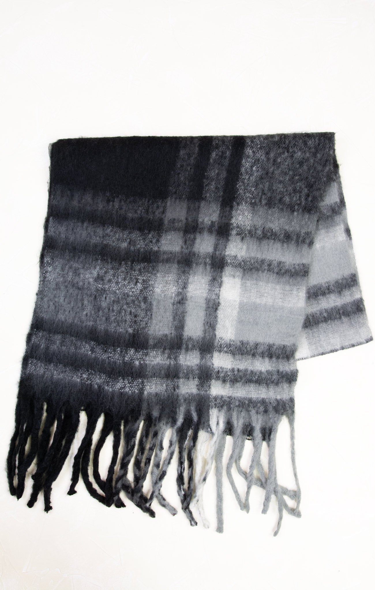 Plaid scarf with black, gray, and white colors on a white background