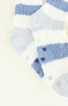 Close-up of blue and white striped socks with heart patterns on a light background