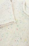 Close-up of a textured fabric with colorful speckles on a white background