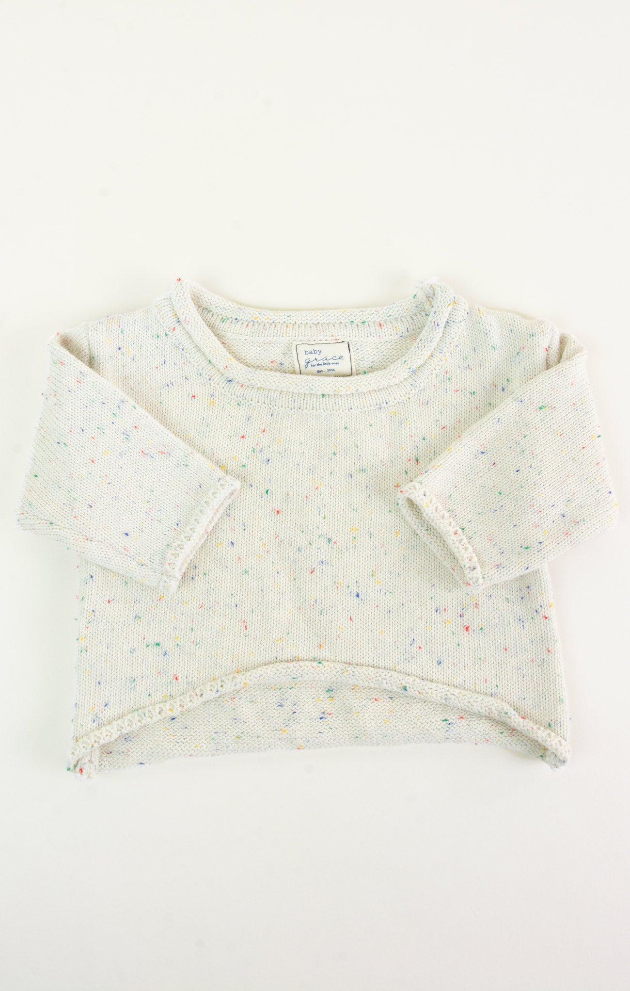 Baby sweater with colorful patterns on a white background
