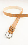 Tan leather belt with silver studs on a white background