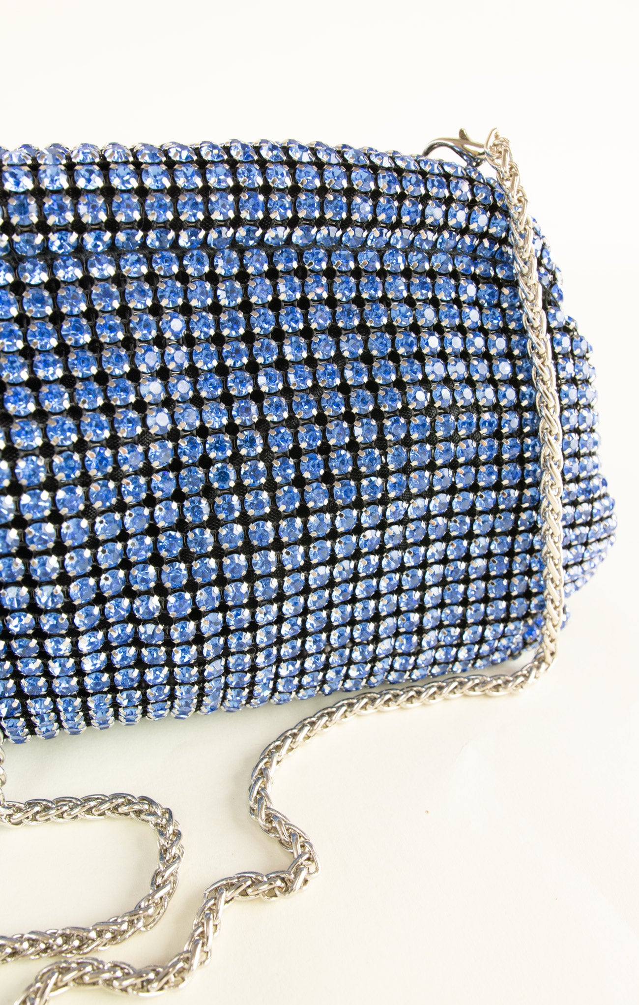Blue rhinestone clutch bag on a white background
