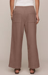 Brown wide-leg pants worn by a person on a beige background