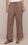 Brown pants worn by a person on a beige background