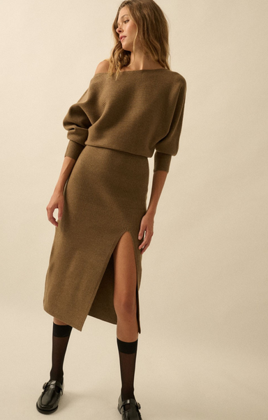 Woman wearing a brown sweater and skirt set on a beige background