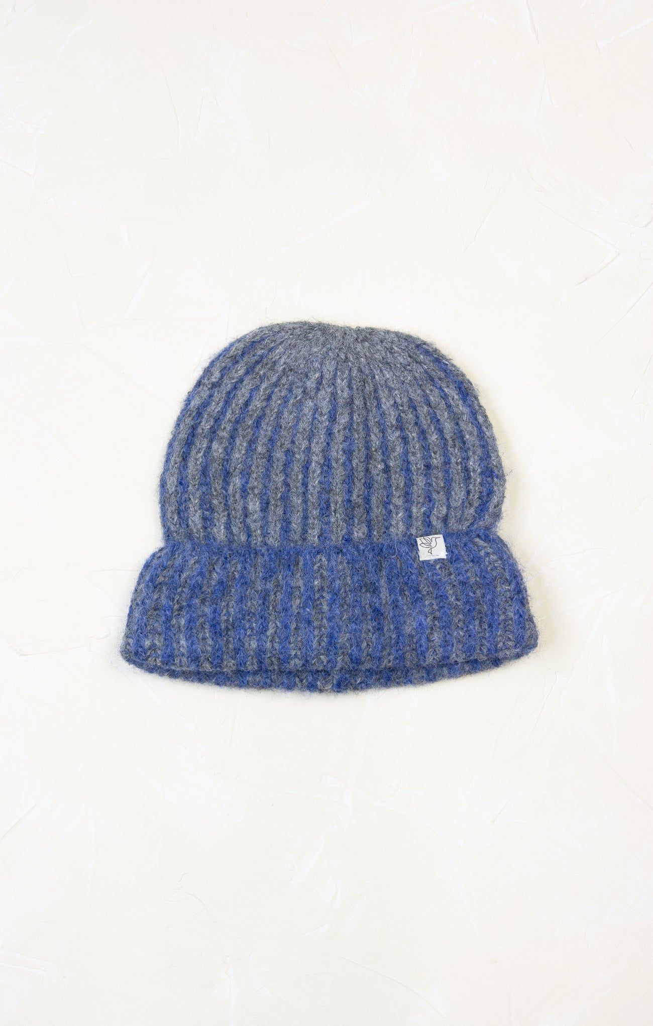 Blue knitted beanie hat on a white background
