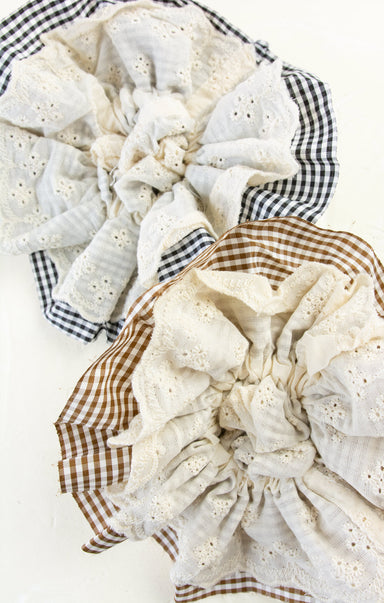 Stack of folded fabric pieces with checkered patterns on a white background