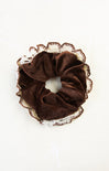 Brown scrunchie with lace trim on a white background