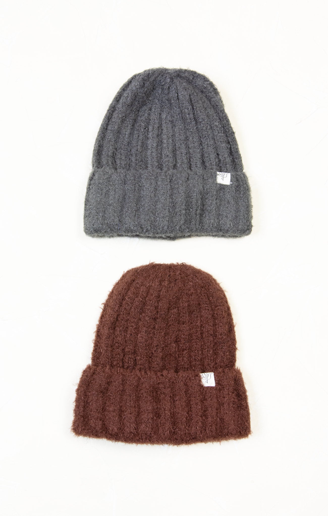 Two knit hats, one gray and one brown, on a white background.