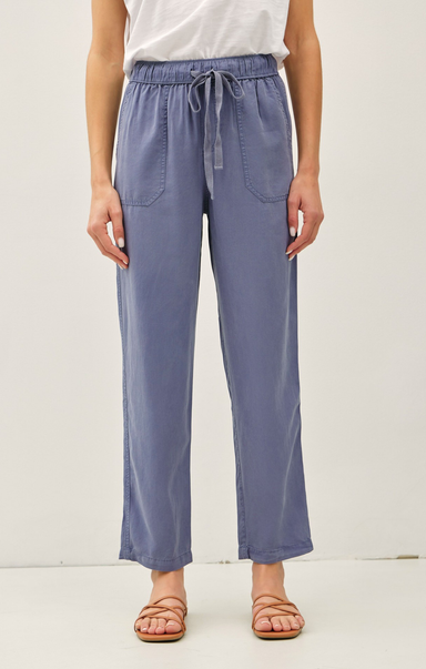 Person wearing blue pants with a white background