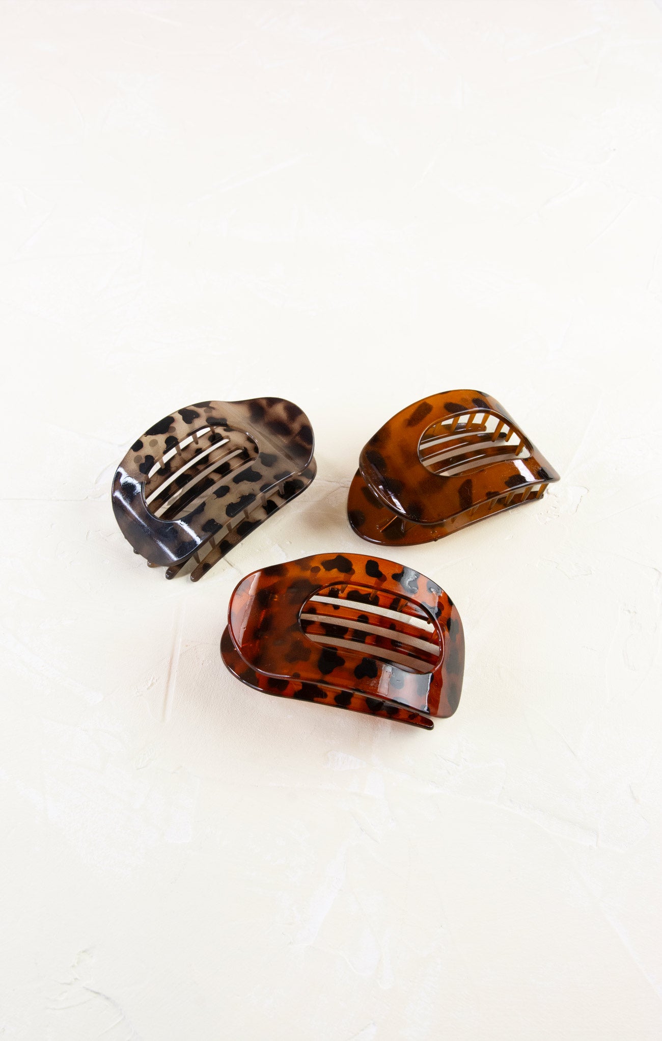 Three tortoiseshell hair clips on a white background