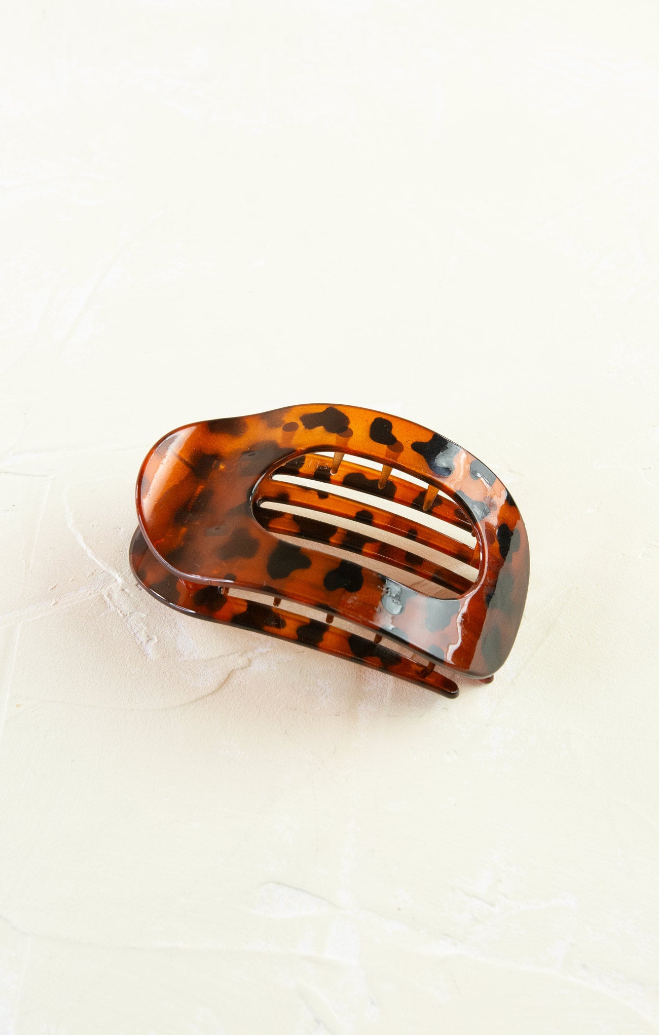 Tortoiseshell hair clip on a light beige background