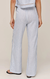 Person wearing light blue and white striped pants on a beige background