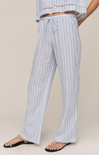 Person wearing blue and white striped pants on a beige background