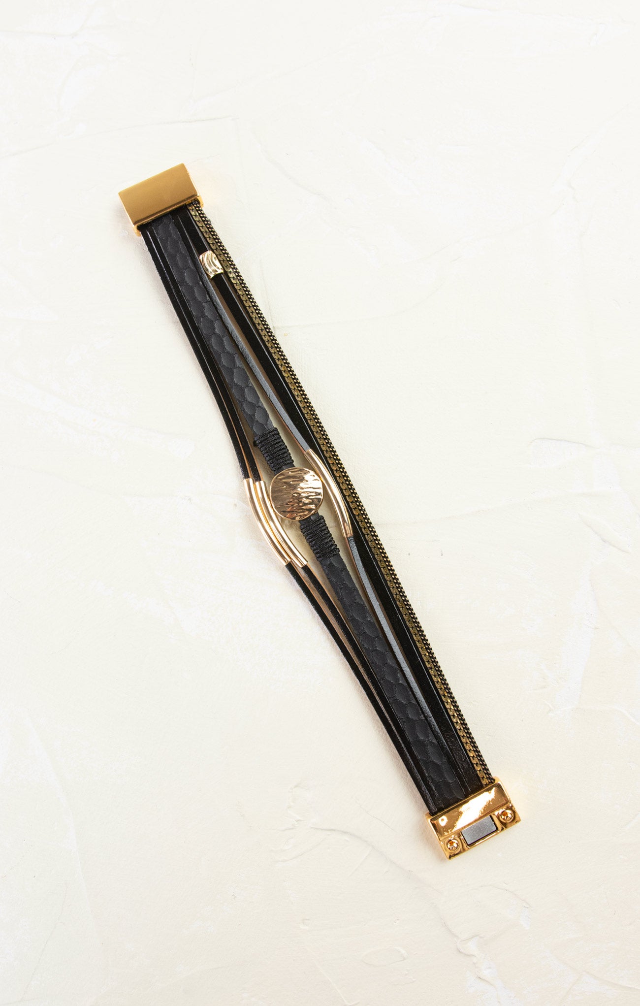 Black and gold watch strap on a white background