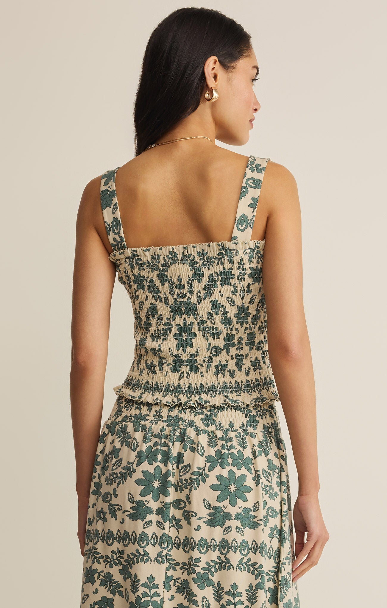 Woman wearing a floral dress with a neutral background