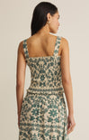 Woman wearing a floral dress with a neutral background