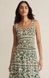 Woman wearing a floral dress against a beige background