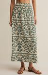 Long floral skirt with green pattern on a neutral background