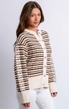 Woman wearing a striped cardigan with a plain background