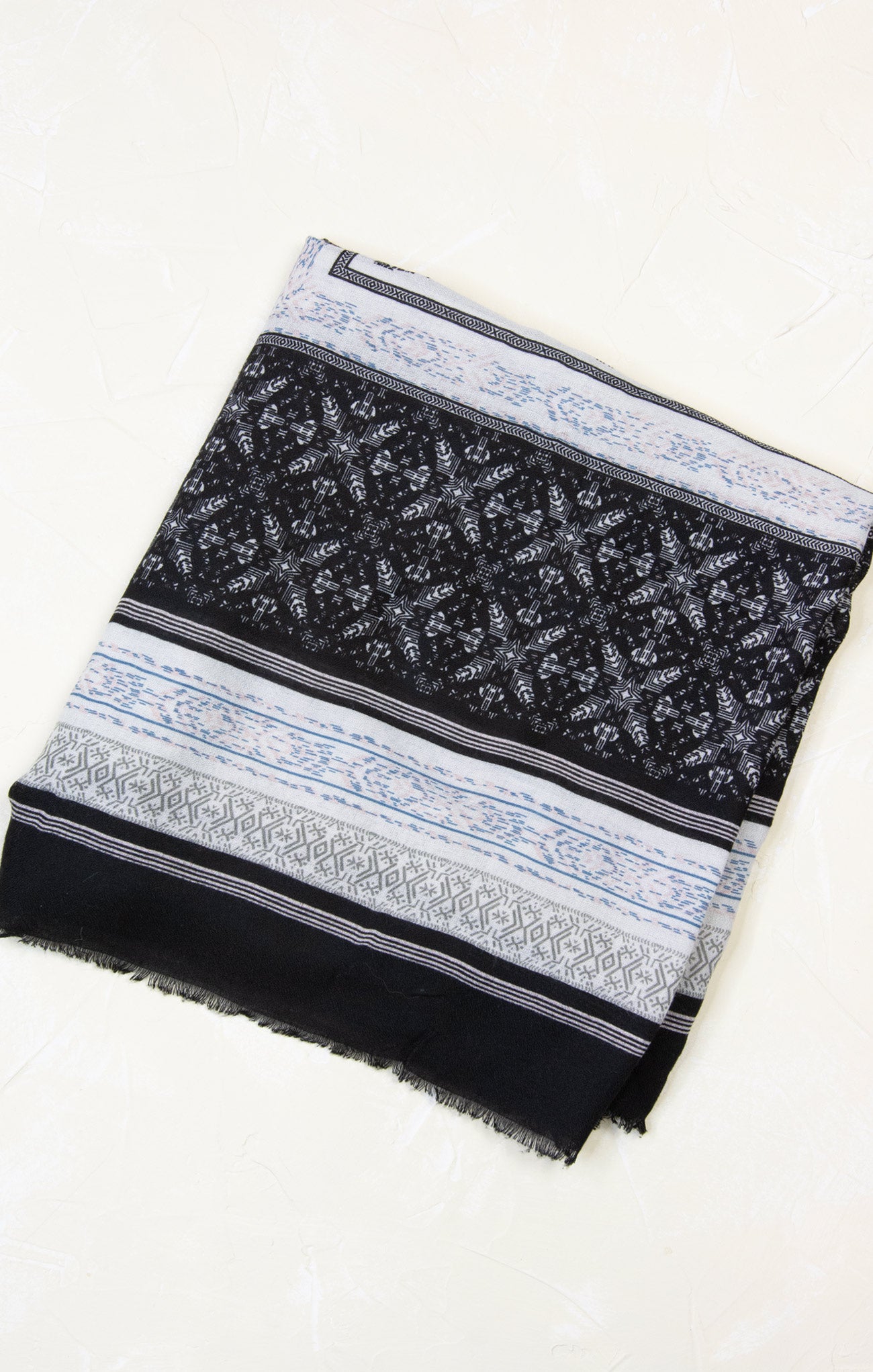 Black and white patterned scarf on a white background