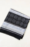 Black and white patterned scarf on a white background