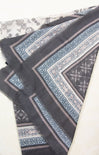 Black fabric with blue and white pattern on a white background