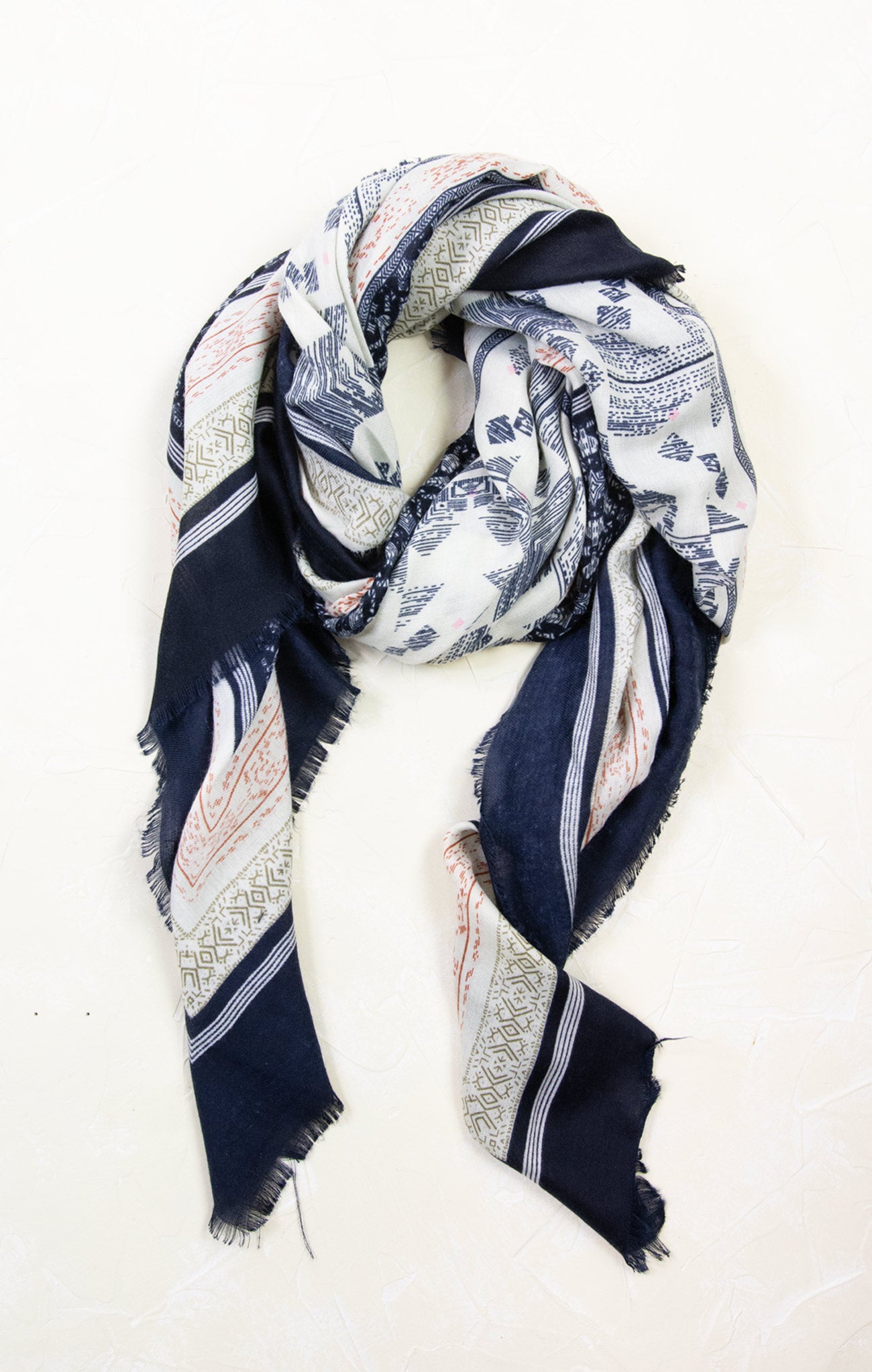 Navy and white patterned scarf on a white background