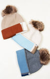 Set of three winter hats with pom-poms on a white background