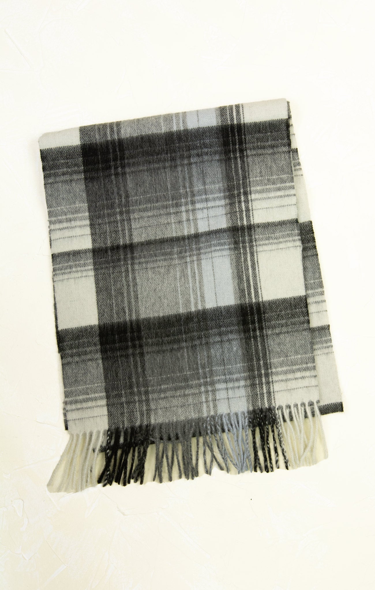 Plaid scarf with black and white pattern on a white background