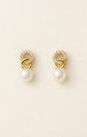 Pair of gold earrings with pearls on a beige background