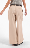 Beige wide-leg pants worn by a person on a white background