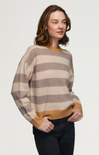 Woman wearing a striped sweater with a neutral background