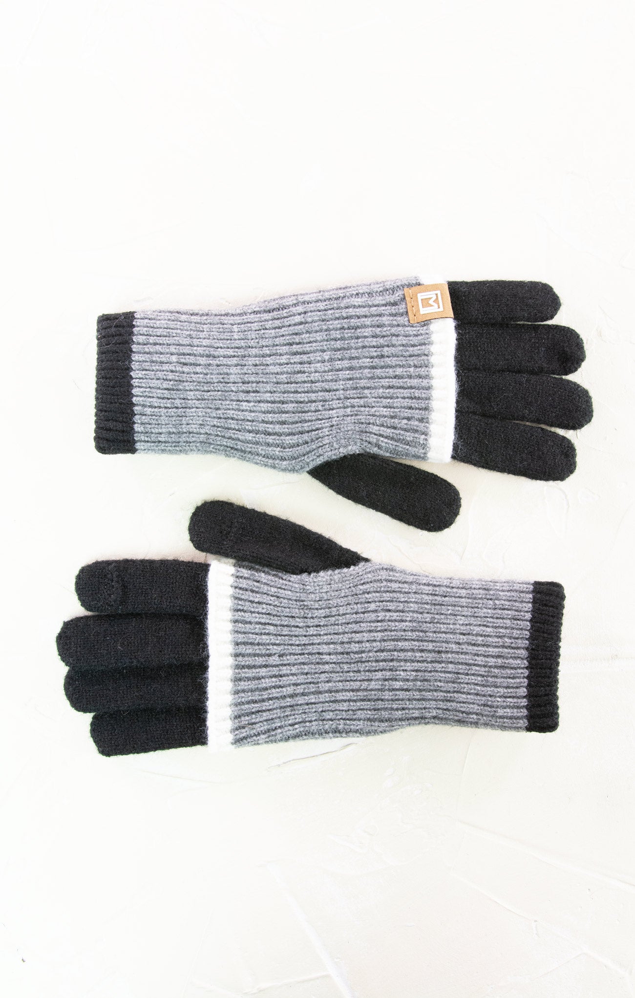 Pair of gray and black gloves on a white background