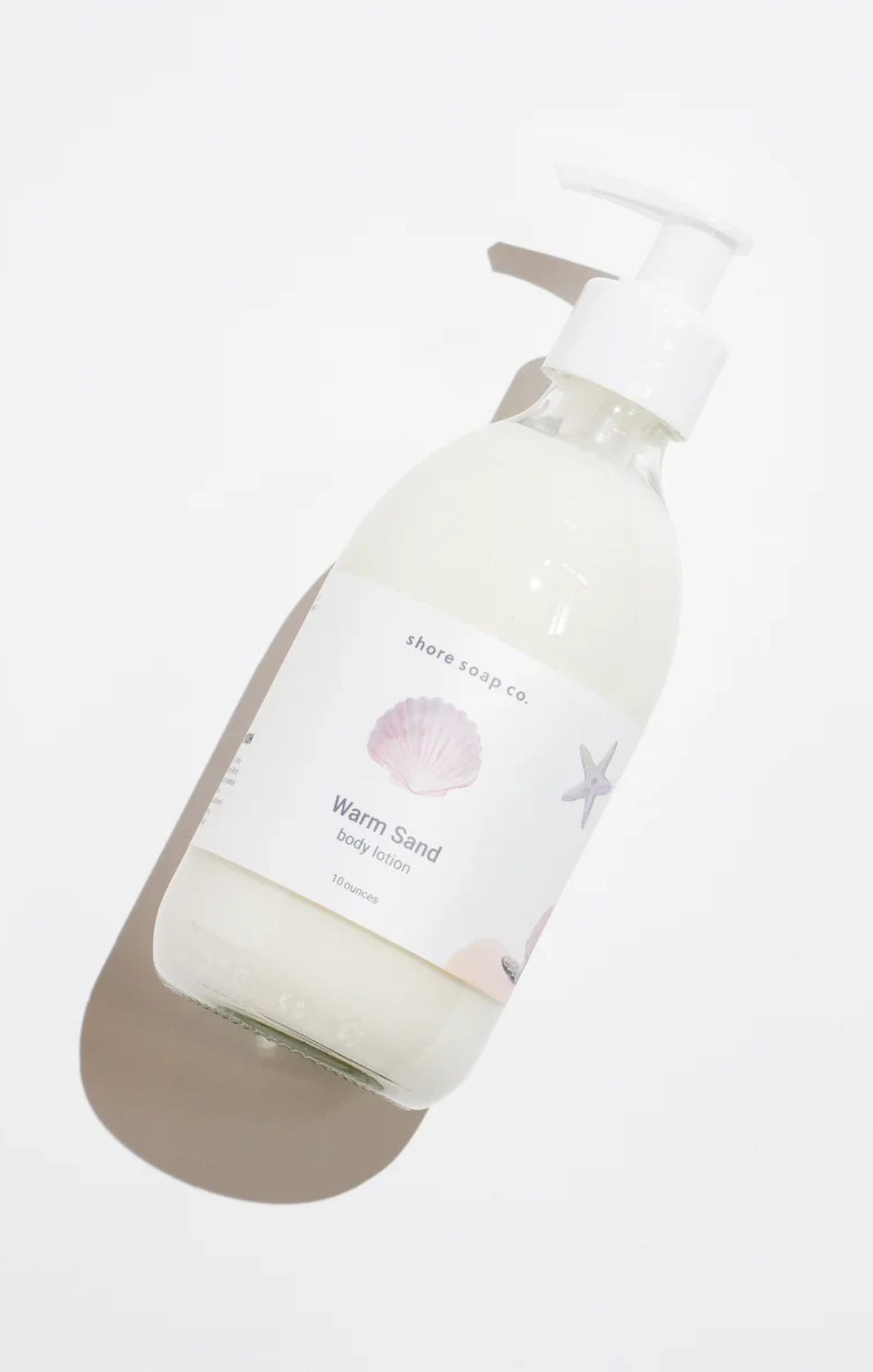 Bottle of 'Warm Sand' bath salt on a white background