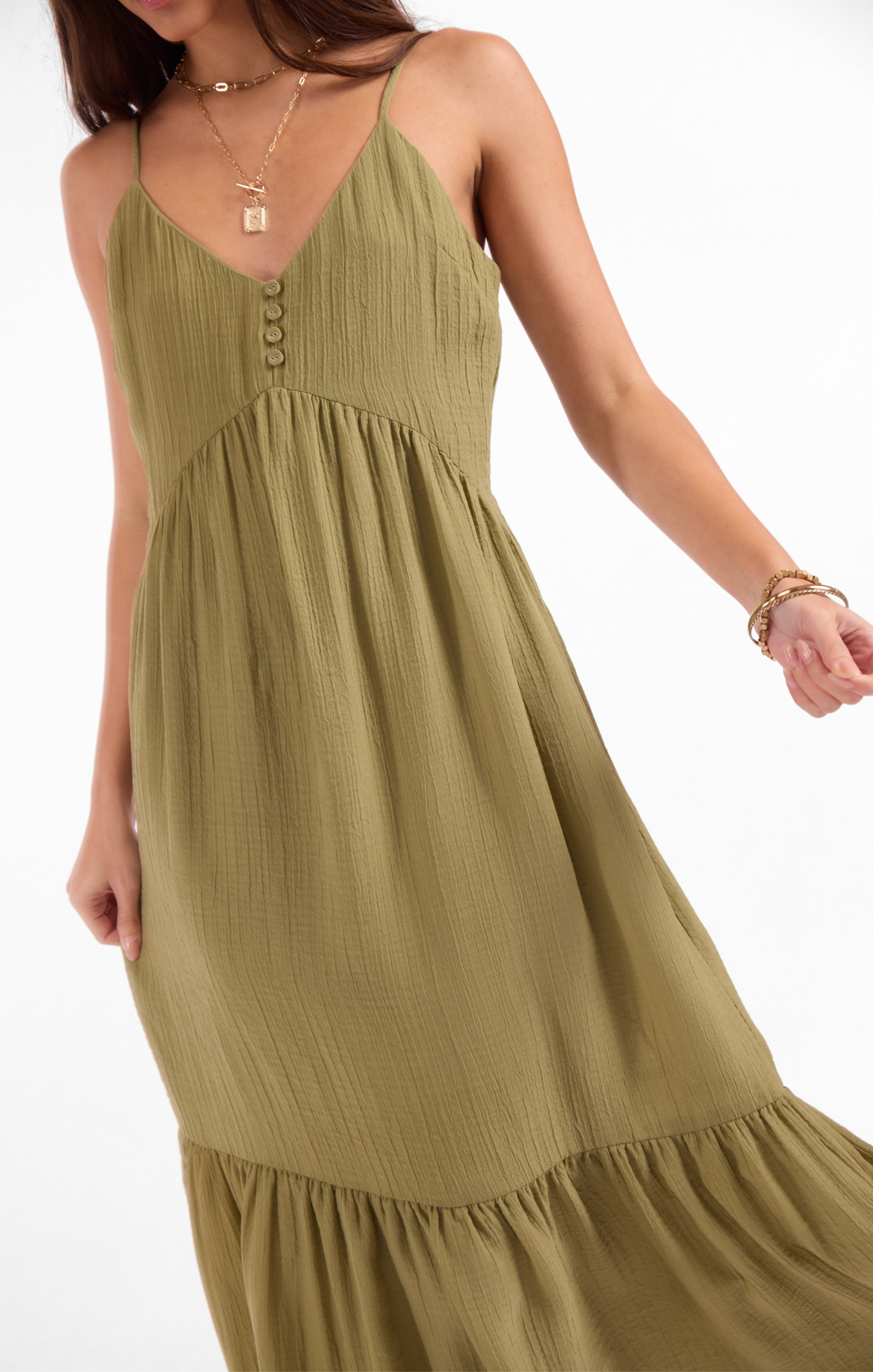 Green dress worn by a person on a white background