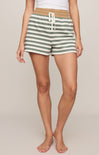 Person wearing green and white striped shorts on a plain background