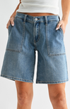 Blue denim shorts worn by a person on a white background