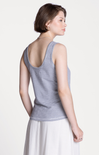 Woman wearing a gray tank top on a white background