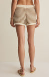Person wearing patterned shorts on a plain background