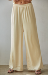 Beige wide-leg pants worn by a person on a plain background