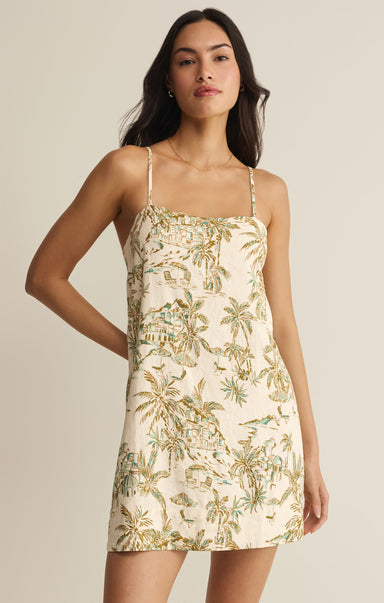 Woman wearing a floral dress against a neutral background