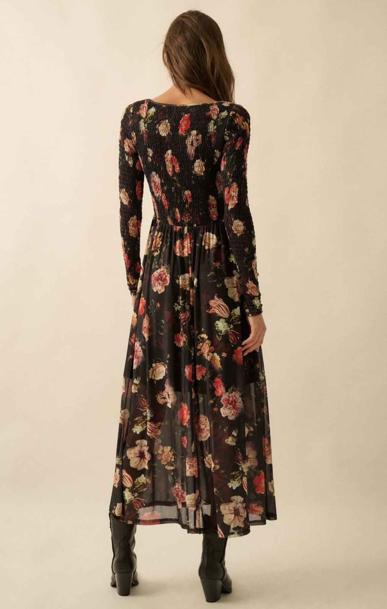 Woman wearing a long floral dress with a neutral background