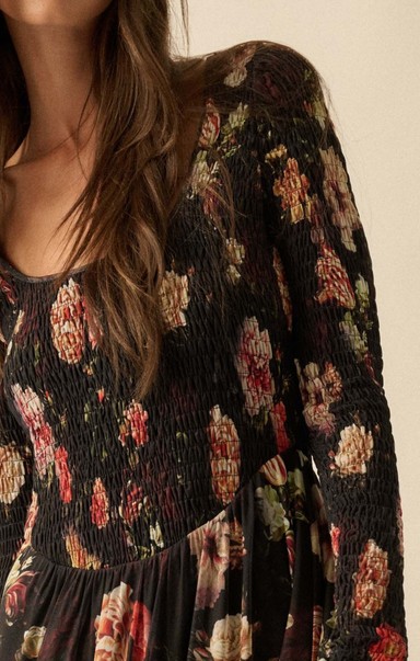 Floral patterned dress with long sleeves on a neutral background