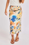 Floral skirt worn by a person on a white background
