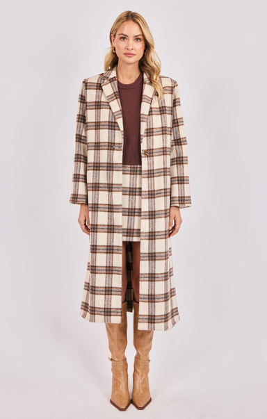 Woman wearing a plaid coat and skirt set on a white background
