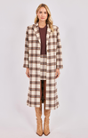 Woman wearing a plaid coat and skirt set on a white background