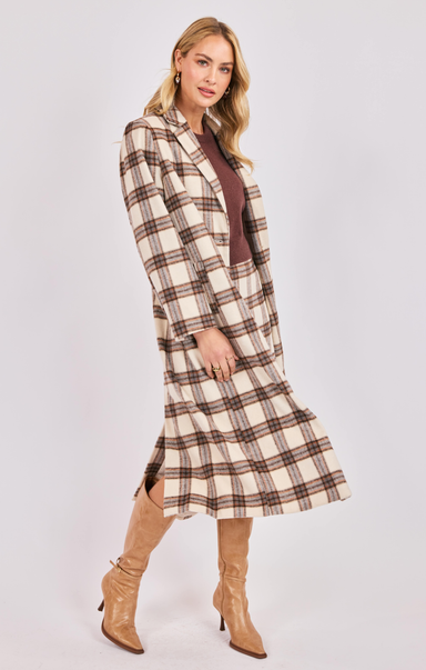 Woman wearing a plaid dress with a white background