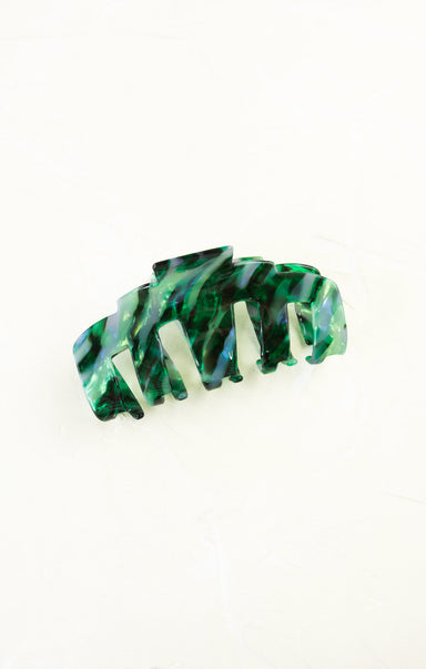 Green and white marbled hair clip on a white background